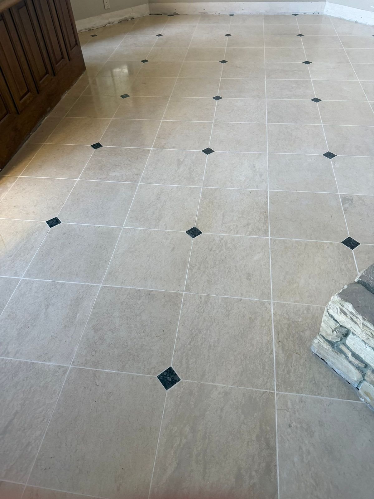 Honed limestone with dark granite dots in Coto de Caza, CA