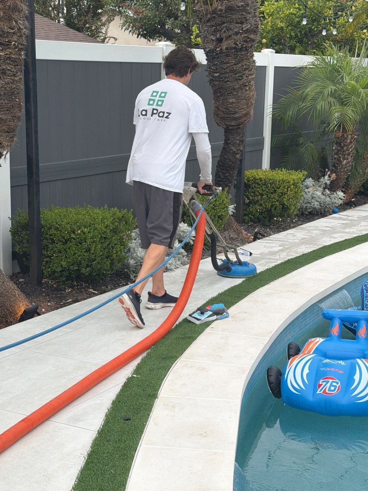 La Paz Floor Care technician cleaning a porcelain pool deck in Ladera Ranch, CA