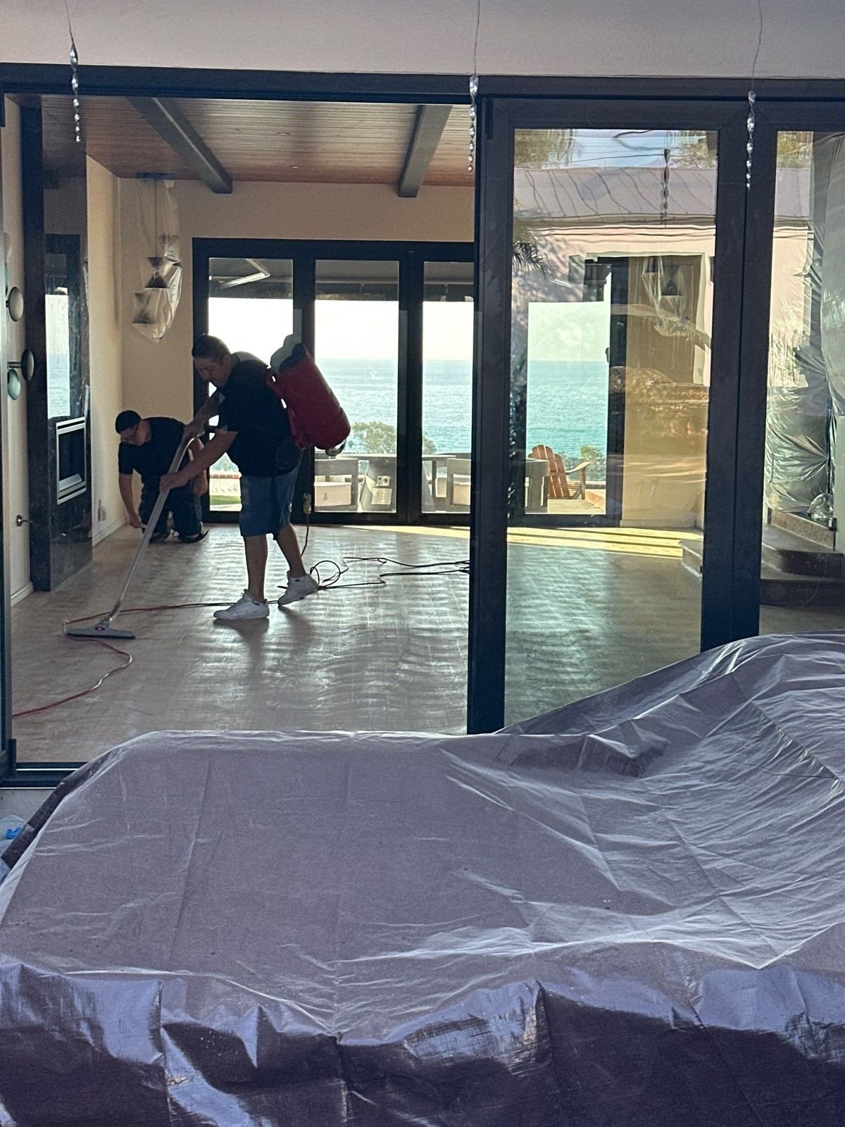 La Paz Floor Care crew refinishing a hardwood floor in an ocean-view home in Laguna Beach, CA