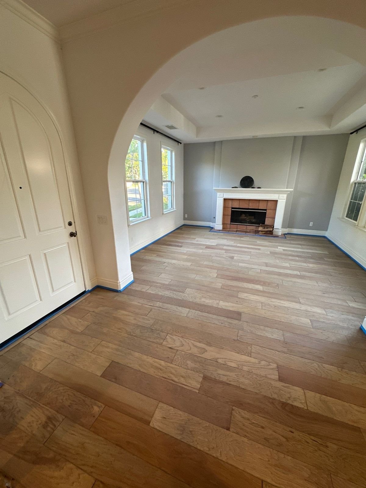 Refinished hickory hardwood floor through an arched entry in Laguna Hills, CA