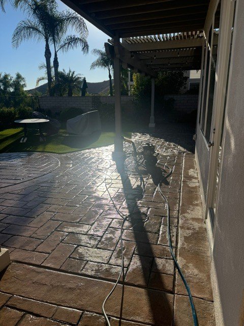 Stamped concrete patio mid pressure wash in Laguna Niguel, CA
