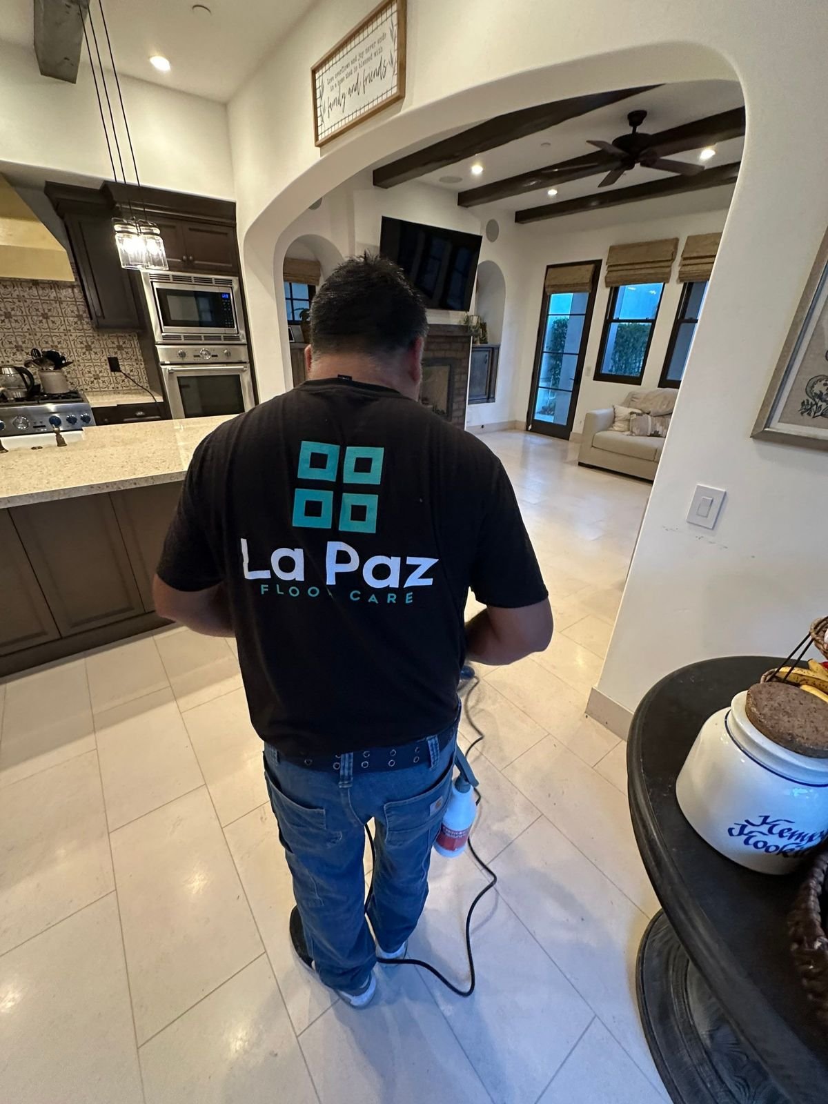 La Paz Floor Care technician polishing a stone floor in a Mission Viejo, CA home