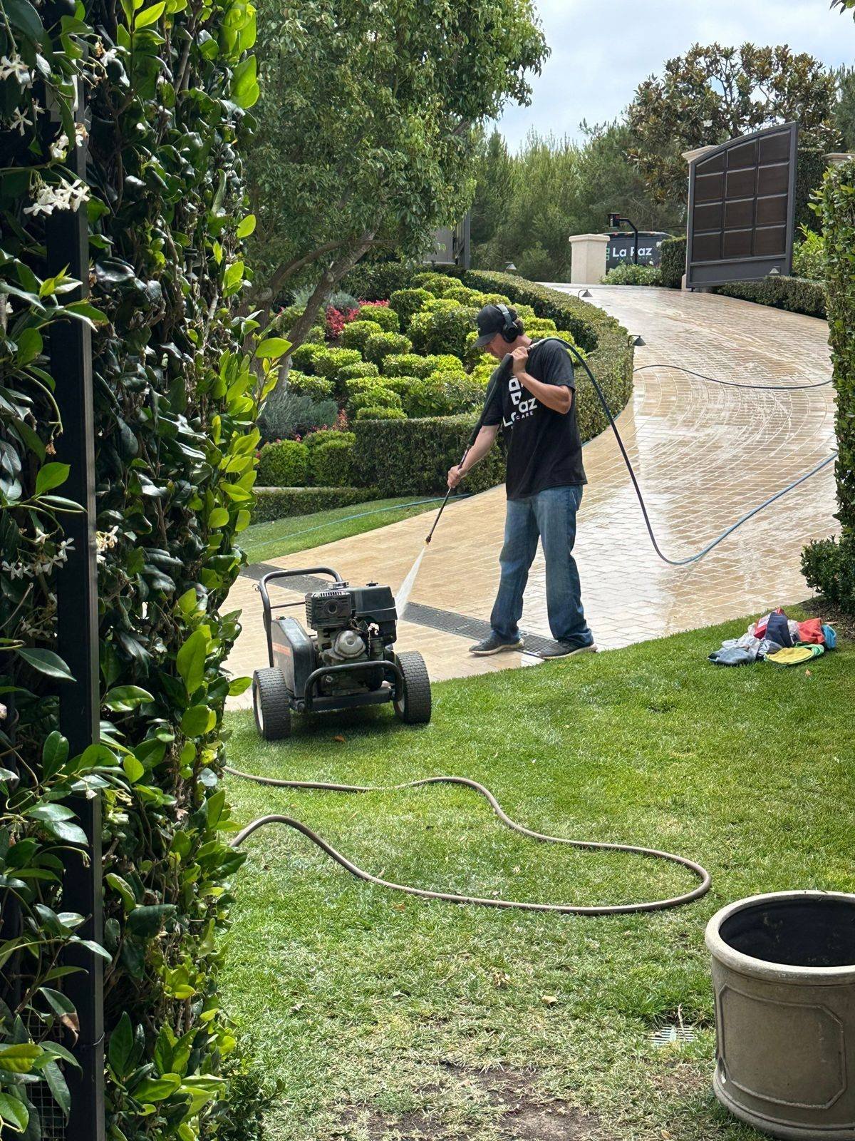 La Paz Floor Care technician pressure washing a paver driveway in San Juan Capistrano, CA